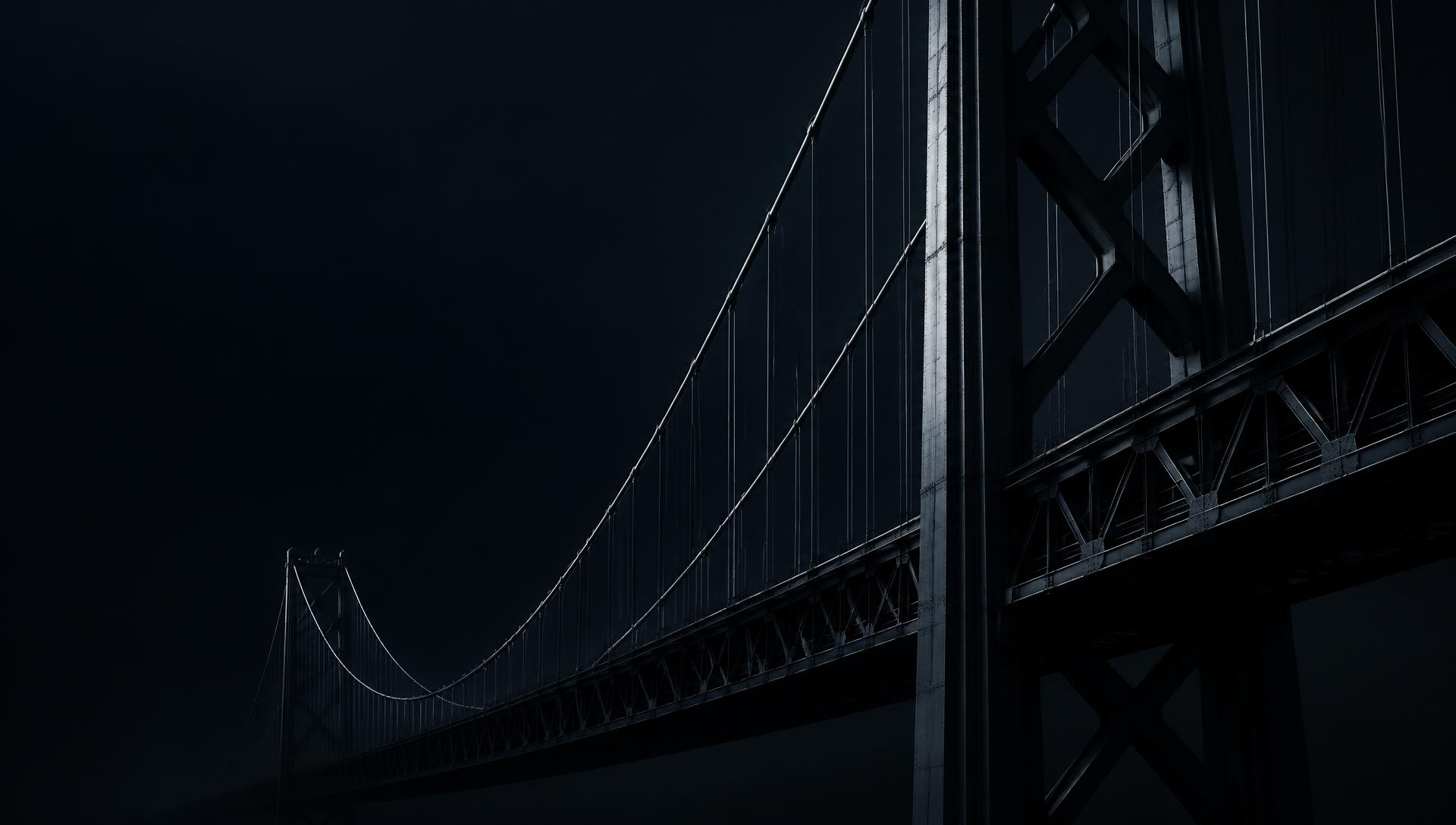 Suspension bridge structure emerging from darkness